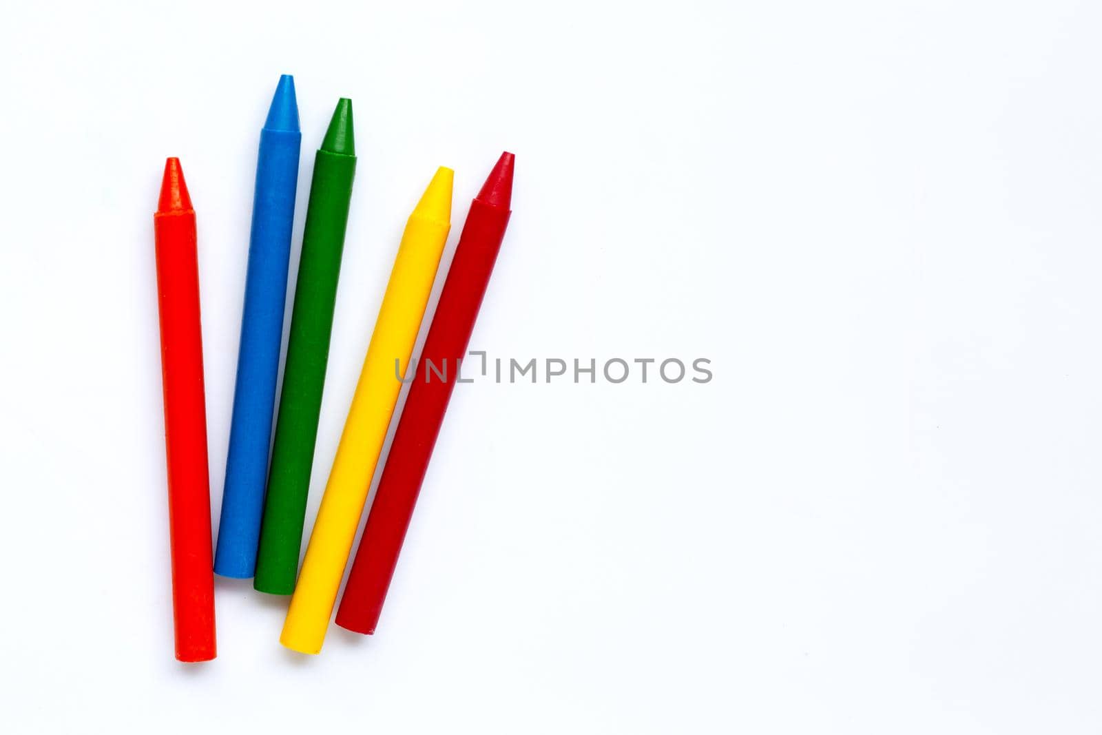 Colorful crayon on white background. Copy space