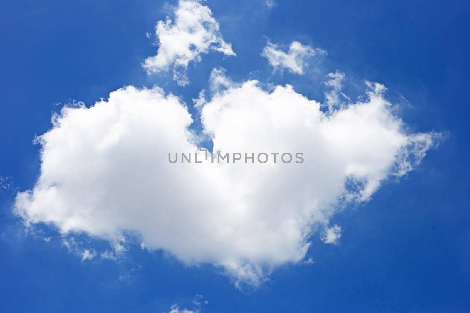 Blue sky background with cloud in the shape of heart. Copy space