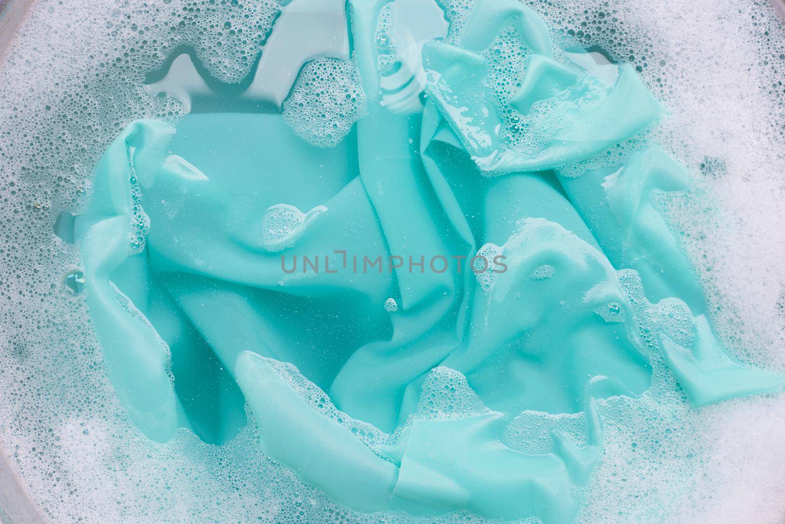 Color clothes soak in powder detergent water dissolution. Laundry concept