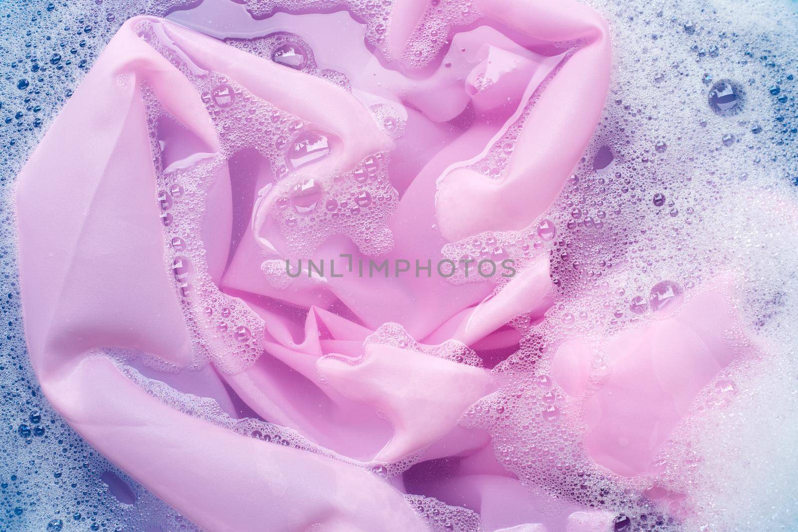 Color clothes soak in powder detergent water dissolution. Laundry concept