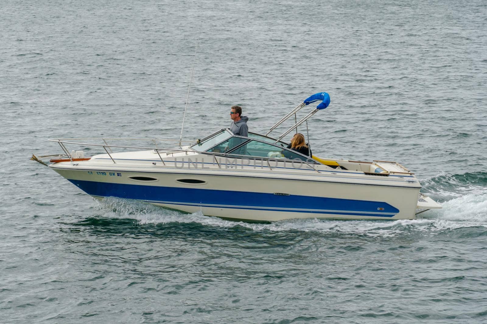 Aerial view of small speed boat in the Mission Bay of San Diego, California, USA. Small power boat yachts cruising on a calm water in the bay. March 22nd, 2020