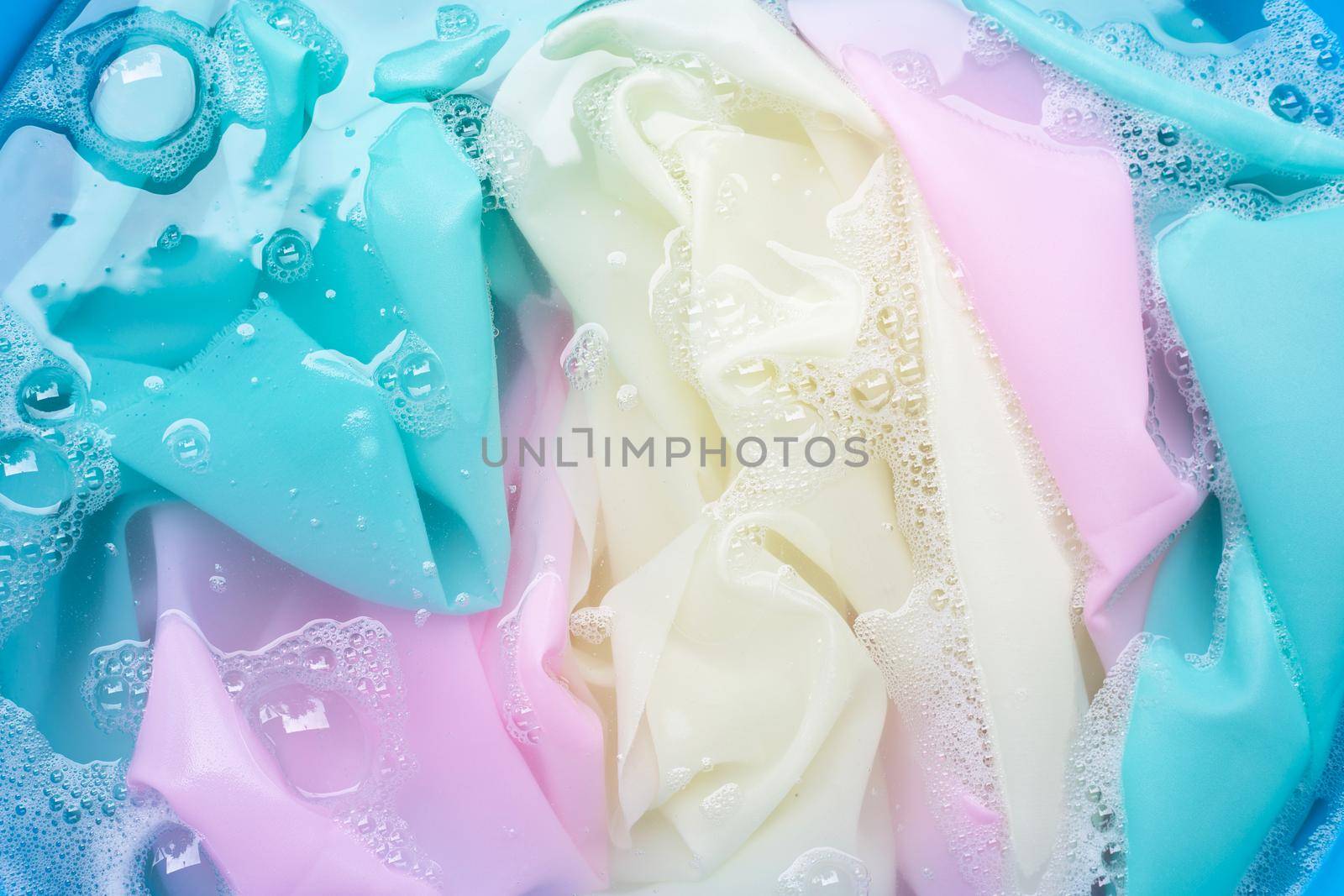 Color clothes soak in powder detergent water dissolution. Laundry concept