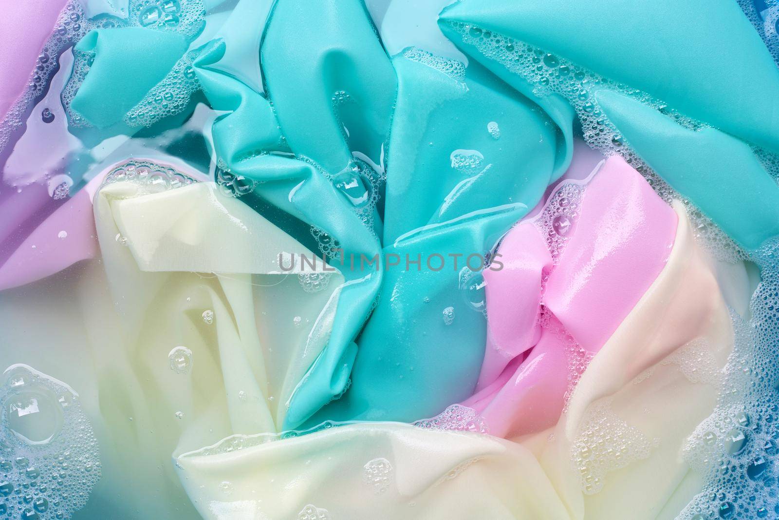 Color clothes soak in powder detergent water dissolution. Laundry concept
