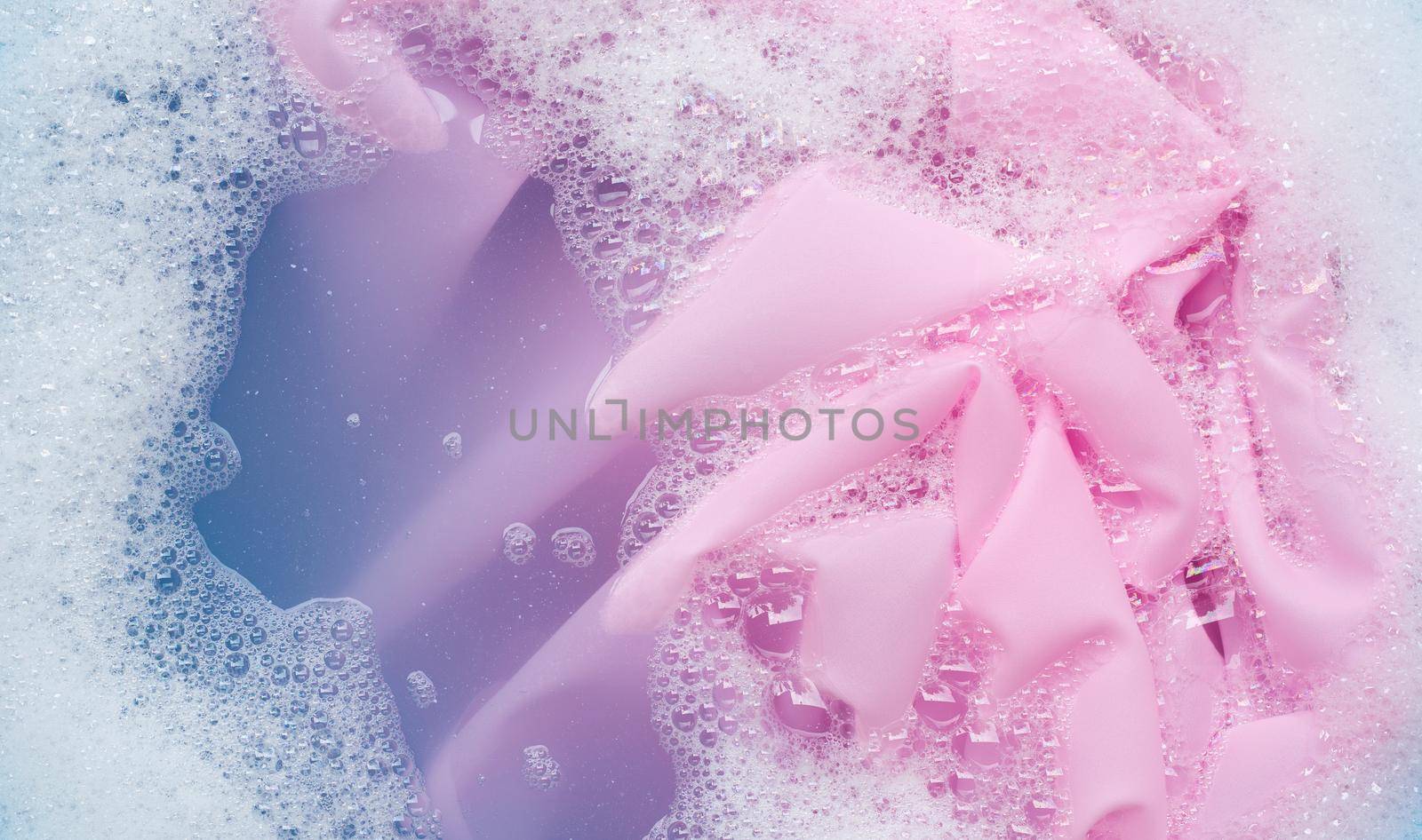 Color clothes soak in powder detergent water dissolution. Laundry concept