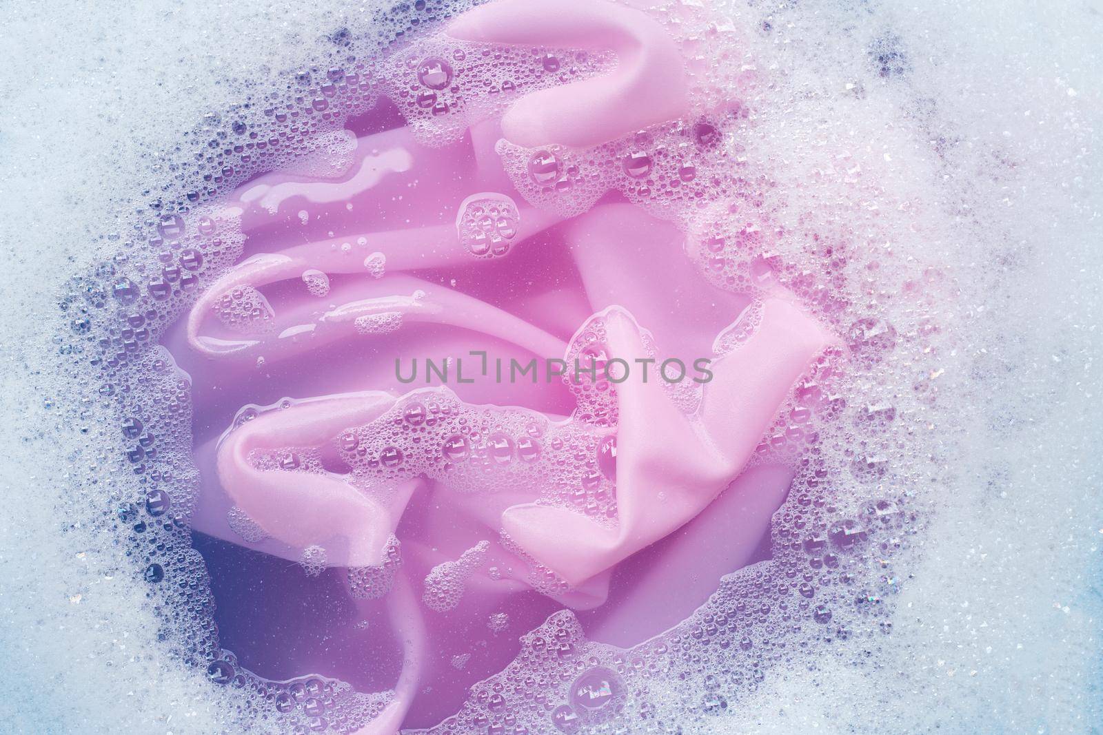 Color clothes soak in powder detergent water dissolution. Laundry concept