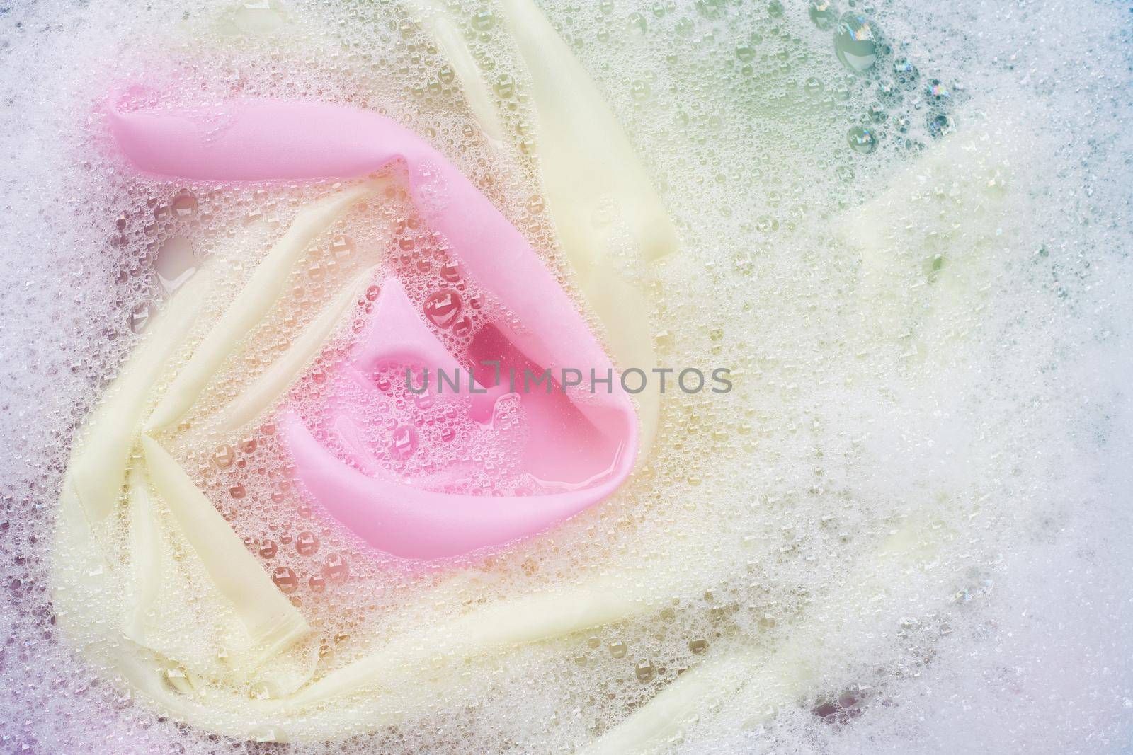 Color clothes soak in powder detergent water dissolution. Laundry concept