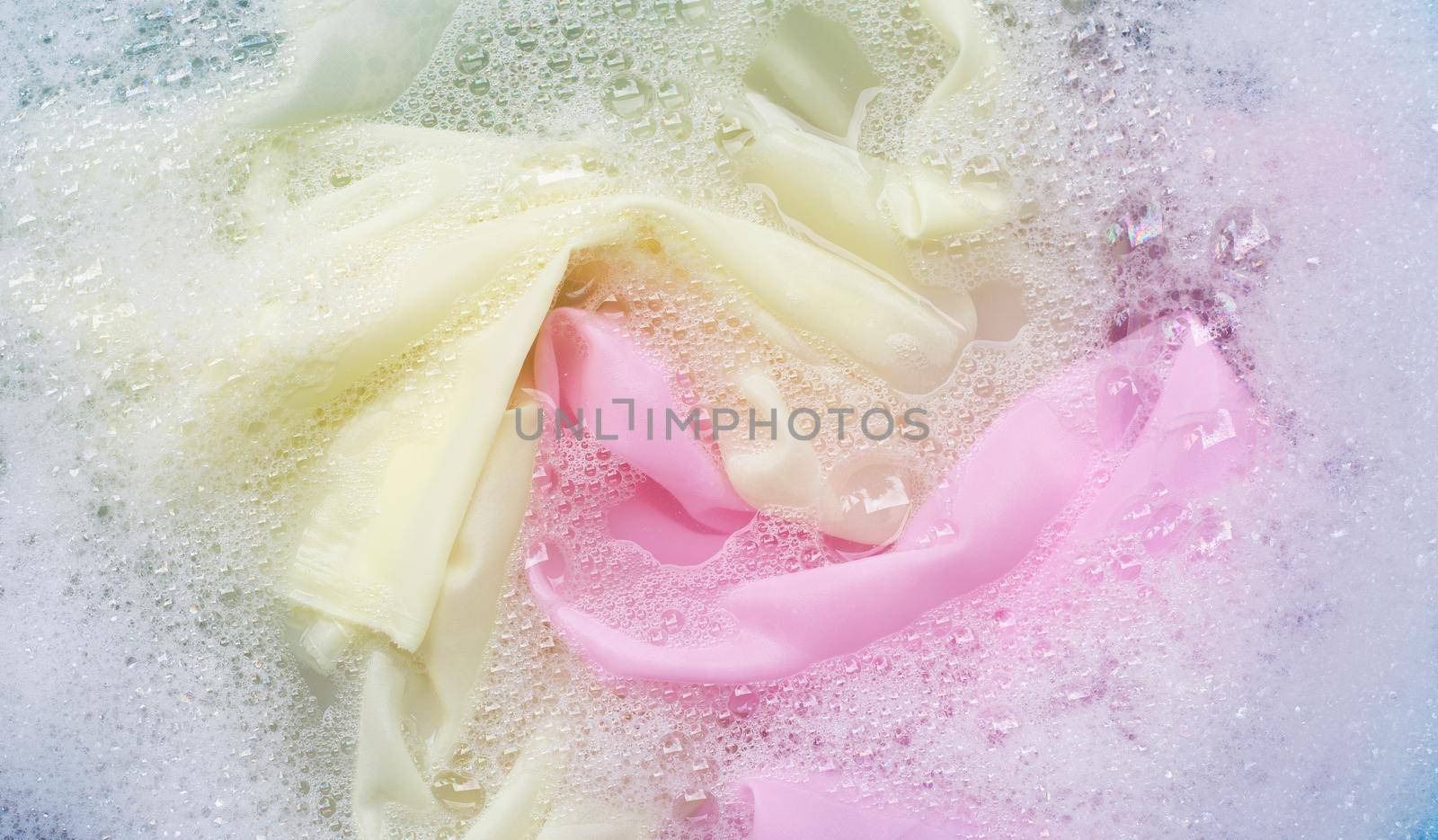 Color clothes soak in powder detergent water dissolution. Laundry concept