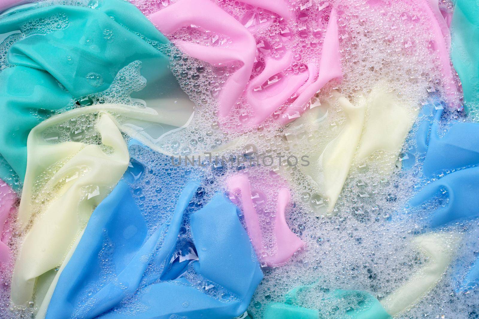 Color clothes soak in powder detergent water dissolution. Laundry concept