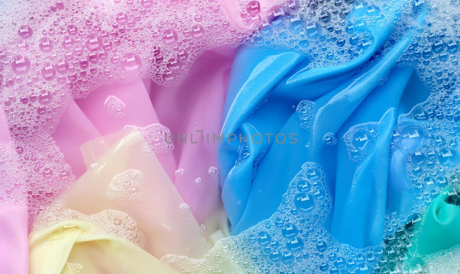 Color clothes soak in powder detergent water dissolution. Laundry concept