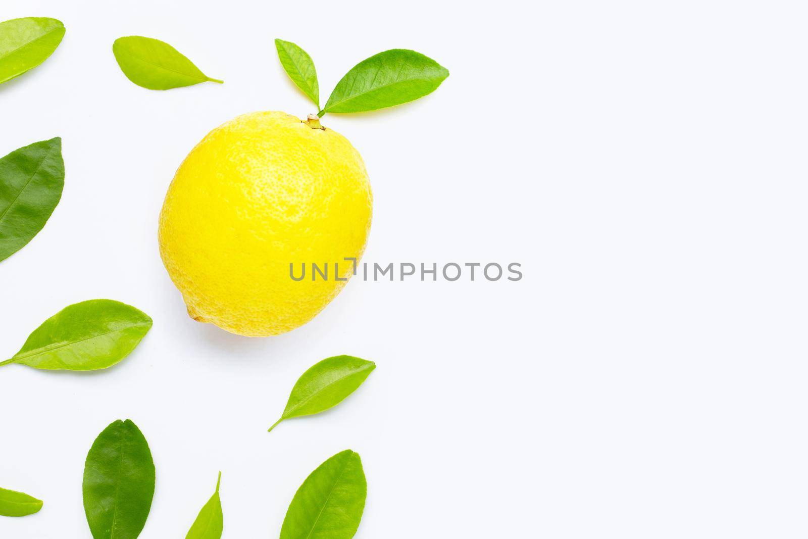 Fresh lemon with green leaves on white background.