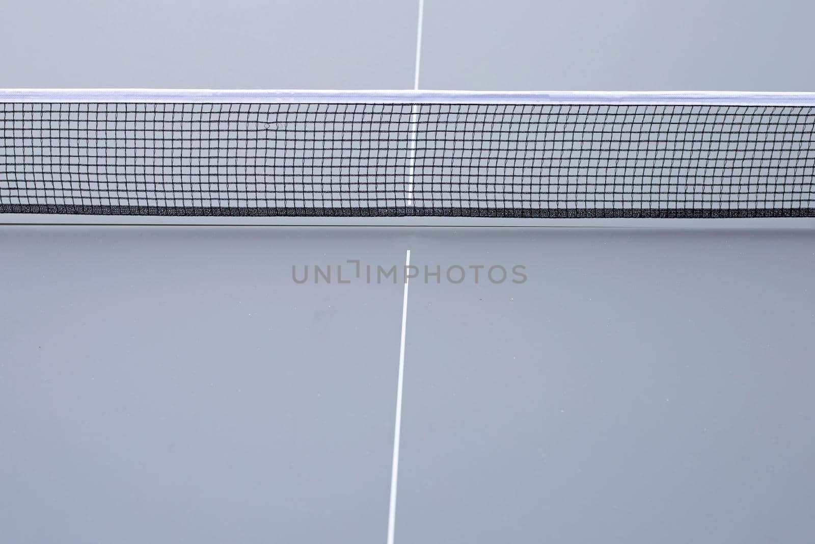 Net of table tennis ping pong on grey background.