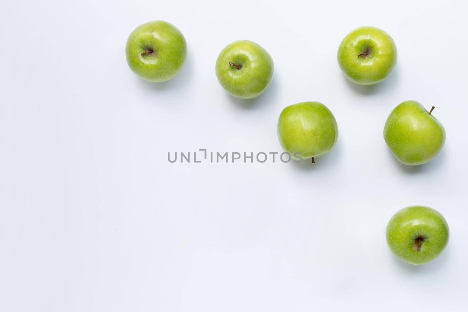 Green apples on white background. Copy space