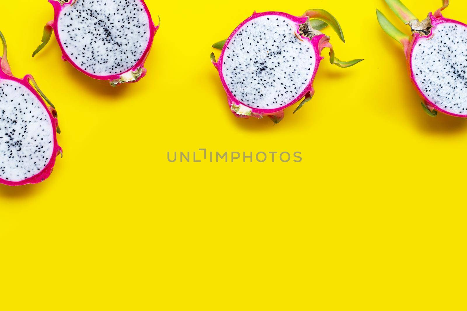 Dragon fruit or pitaya on yellow background. Top view