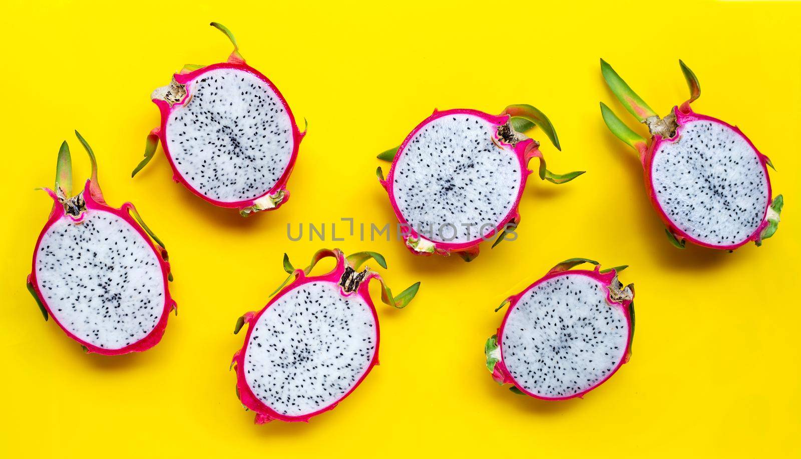 Ripe dragonfruit or pitahaya on yellow background. Top view