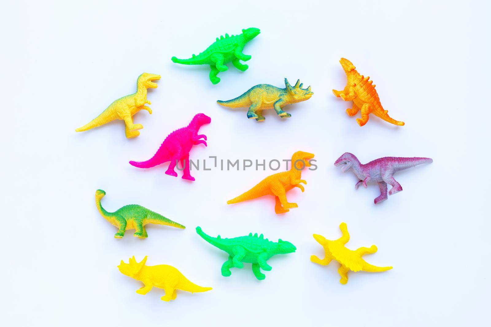 Plastic dinosaur toys on white background. Top view