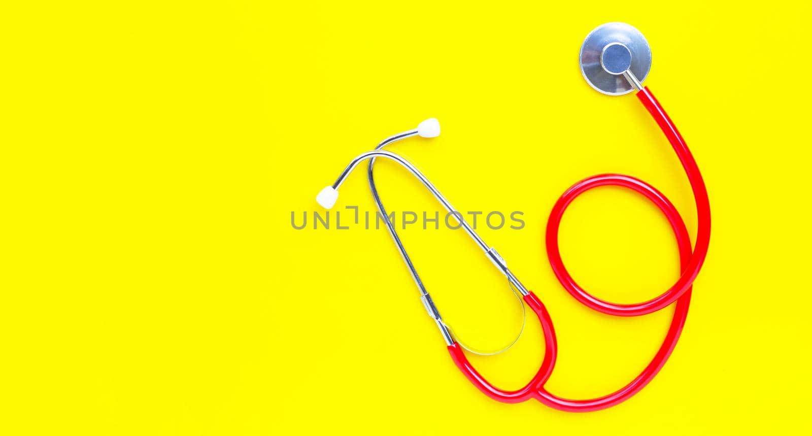 Stethoscope on yellow background. copy space