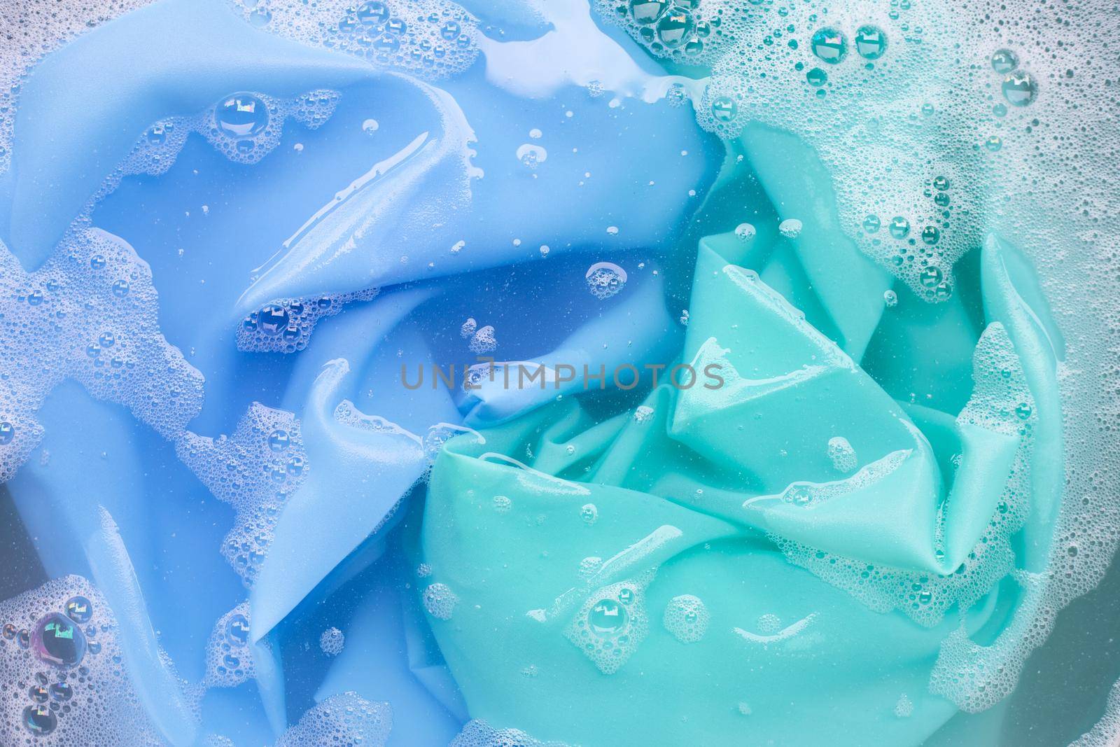 Color clothes soak in powder detergent water dissolution. Laundry concept