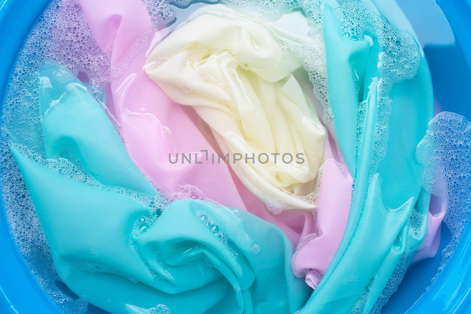 Color clothes soak in powder detergent water dissolution. Laundry concept