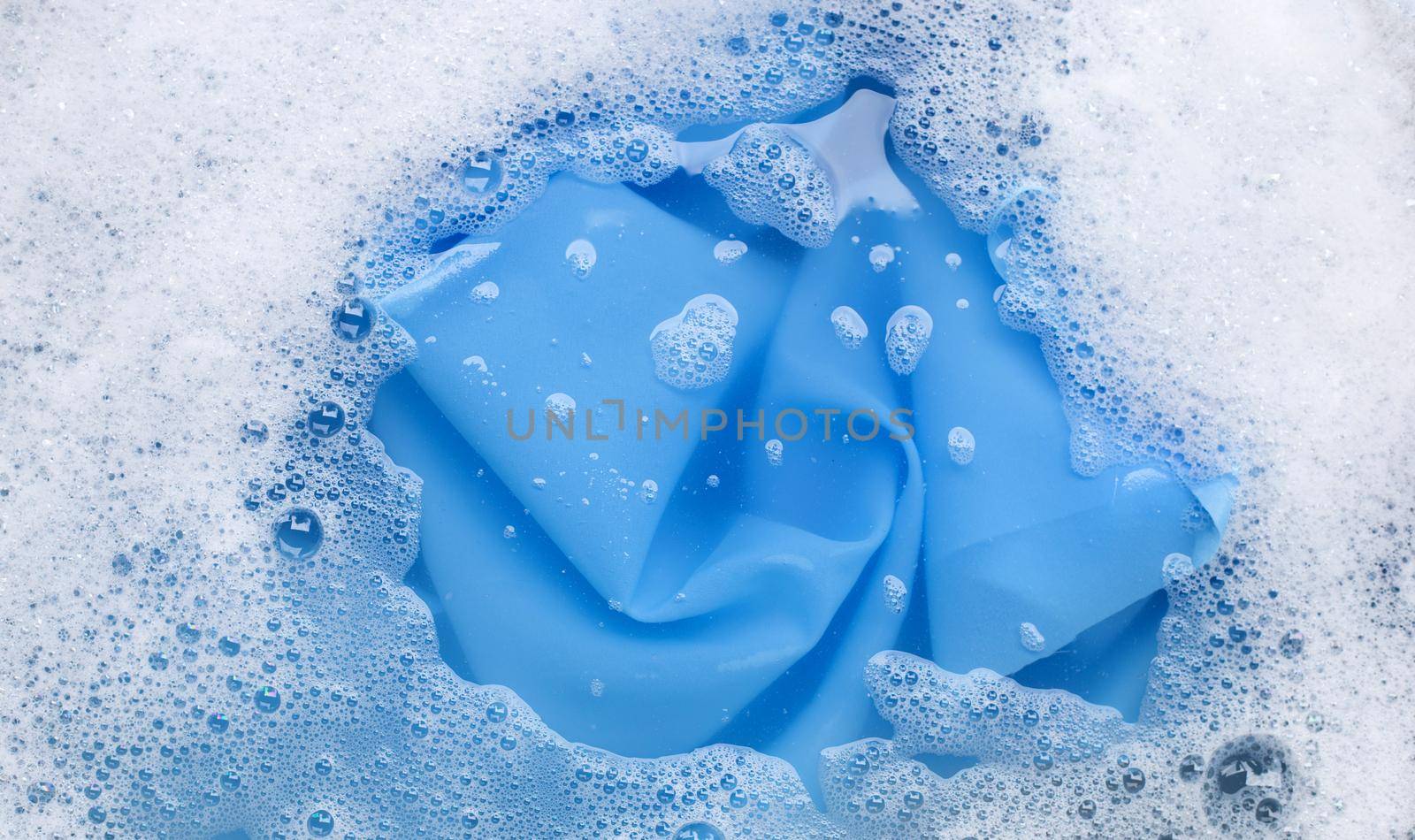 Color clothes soak in powder detergent water dissolution. Laundry concept