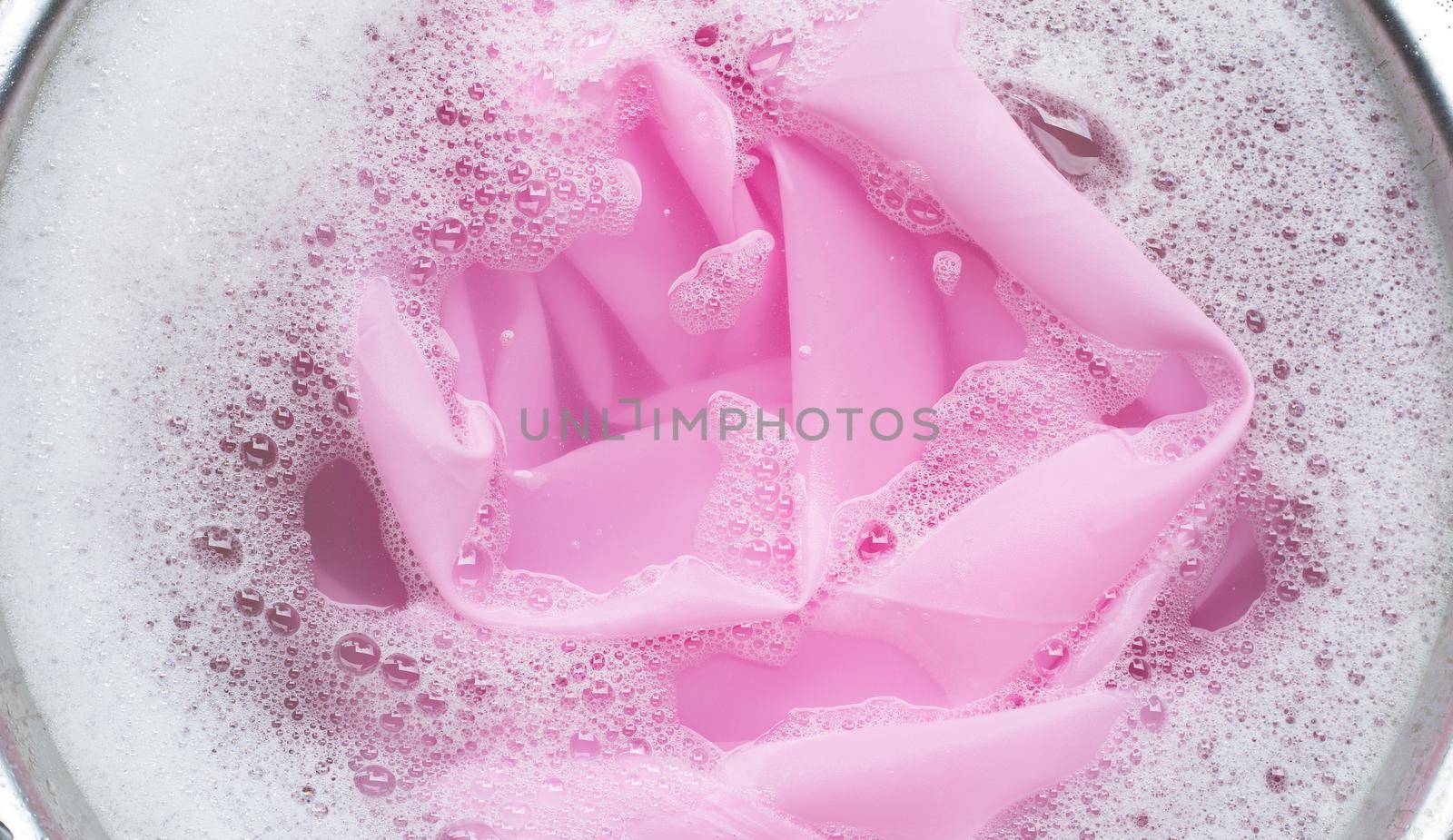 Color clothes soak in powder detergent water dissolution. Laundry concept
