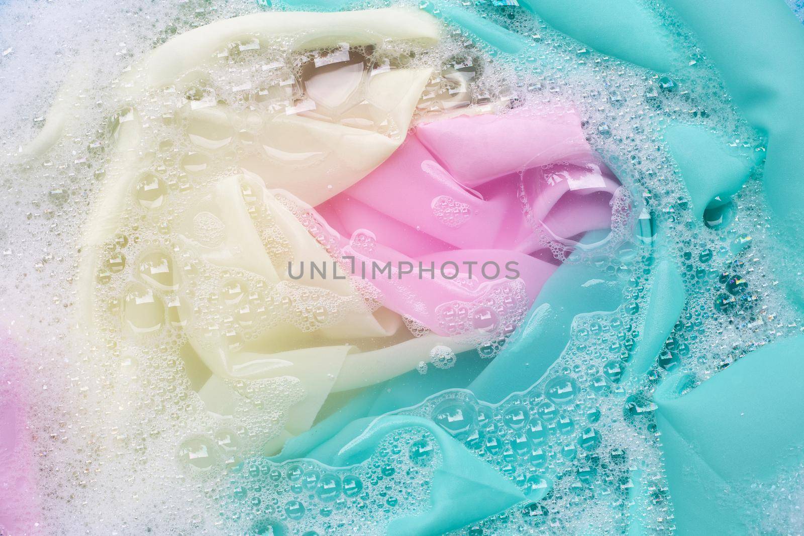 Color clothes soak in powder detergent water dissolution. Laundry concept
