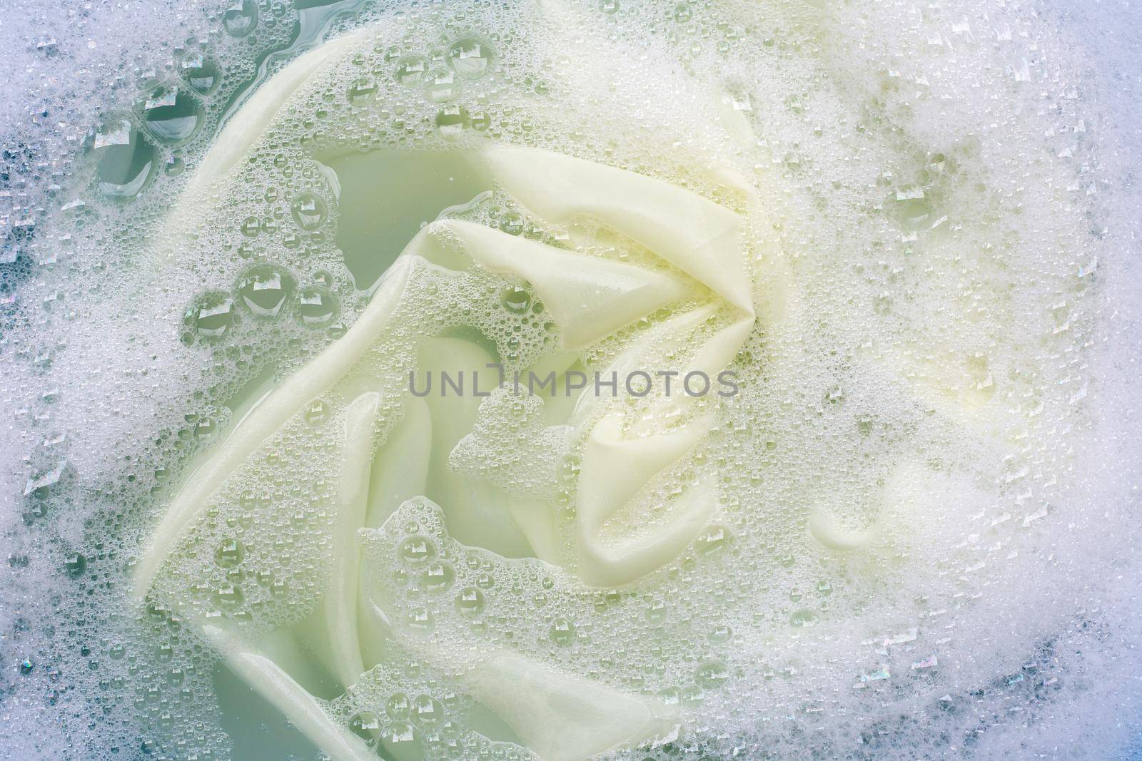 Color clothes soak in powder detergent water dissolution. Laundry concept