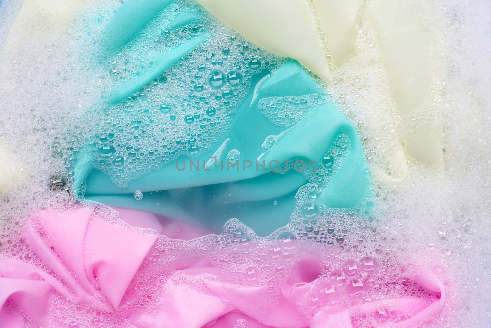 Color clothes soak in powder detergent water dissolution. Laundry concept