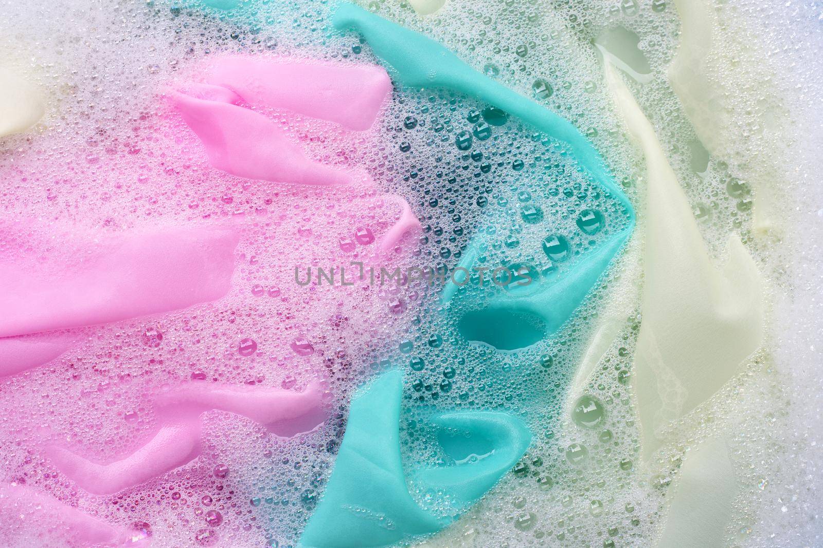 Color clothes soak in powder detergent water dissolution. Laundry concept