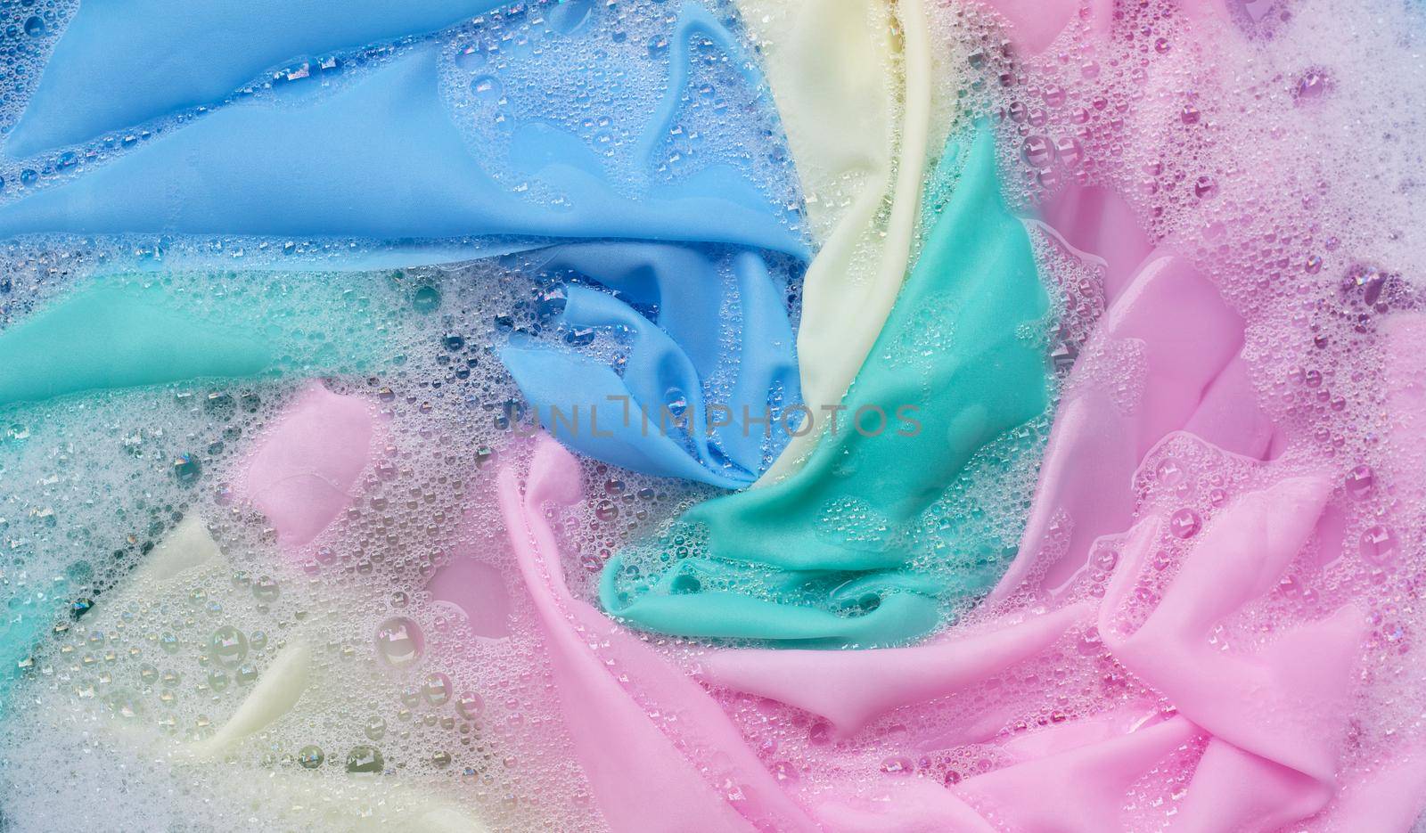 Color clothes soak in powder detergent water dissolution. Laundry concept