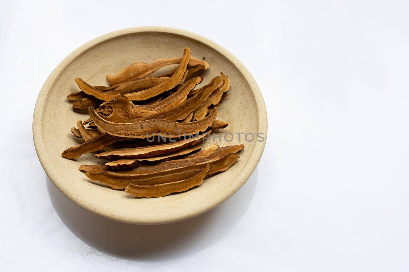 Dried lingzhi mushroom slices on white background