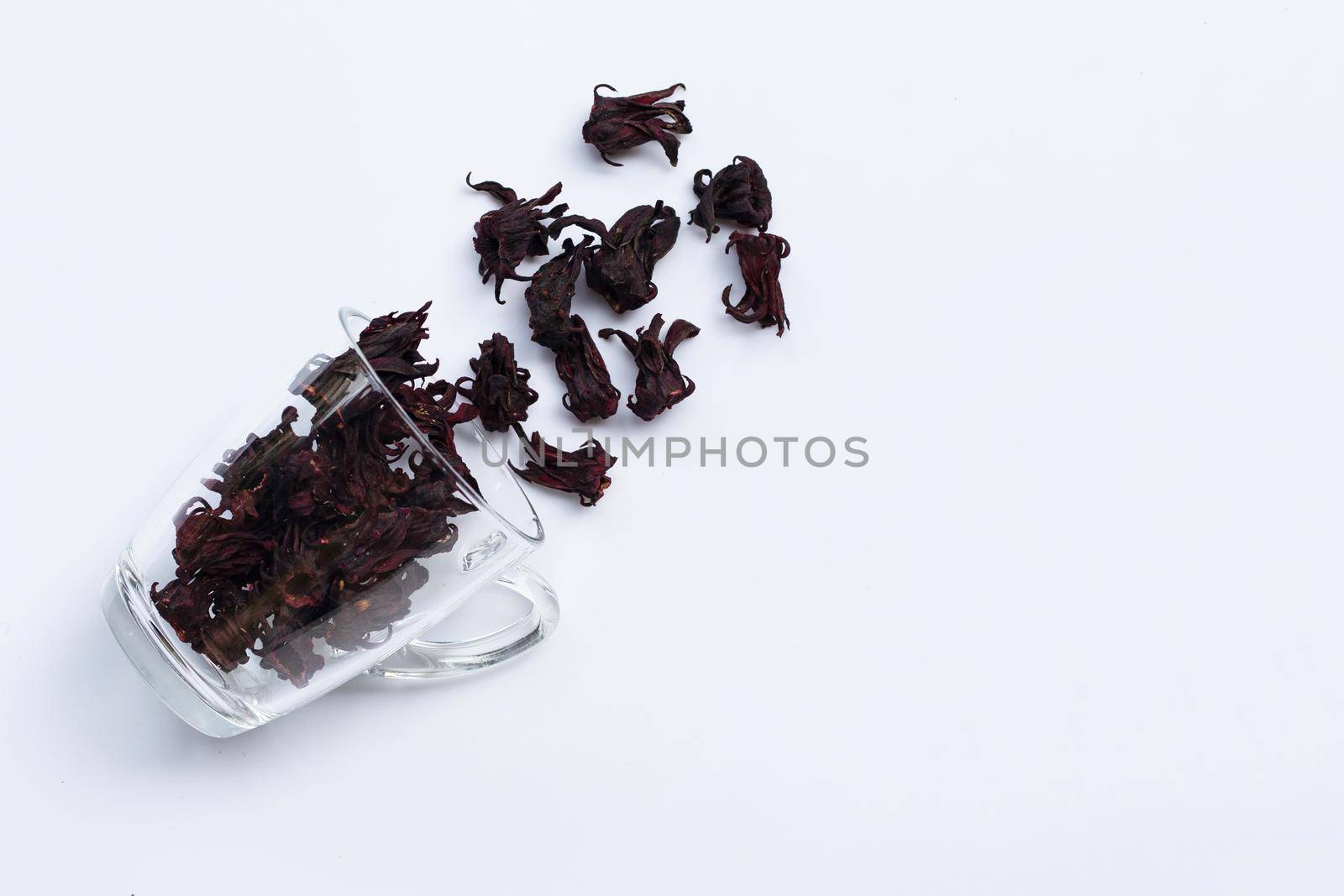 Glass with dried roselle flower isolated on white background. Top viewTop view