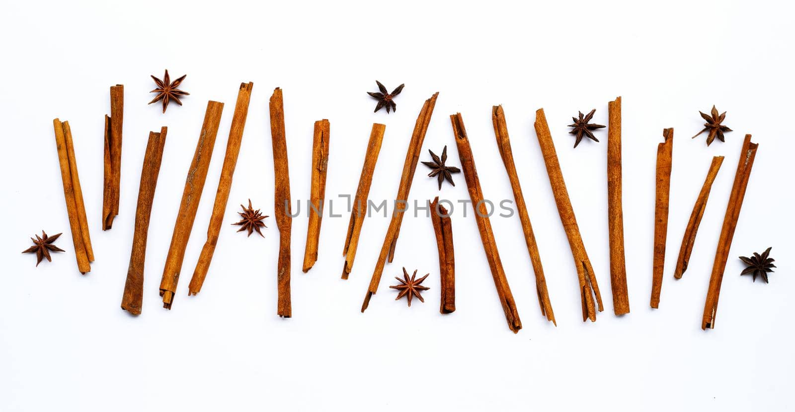 Star anis and cinnamon sticks on white background.