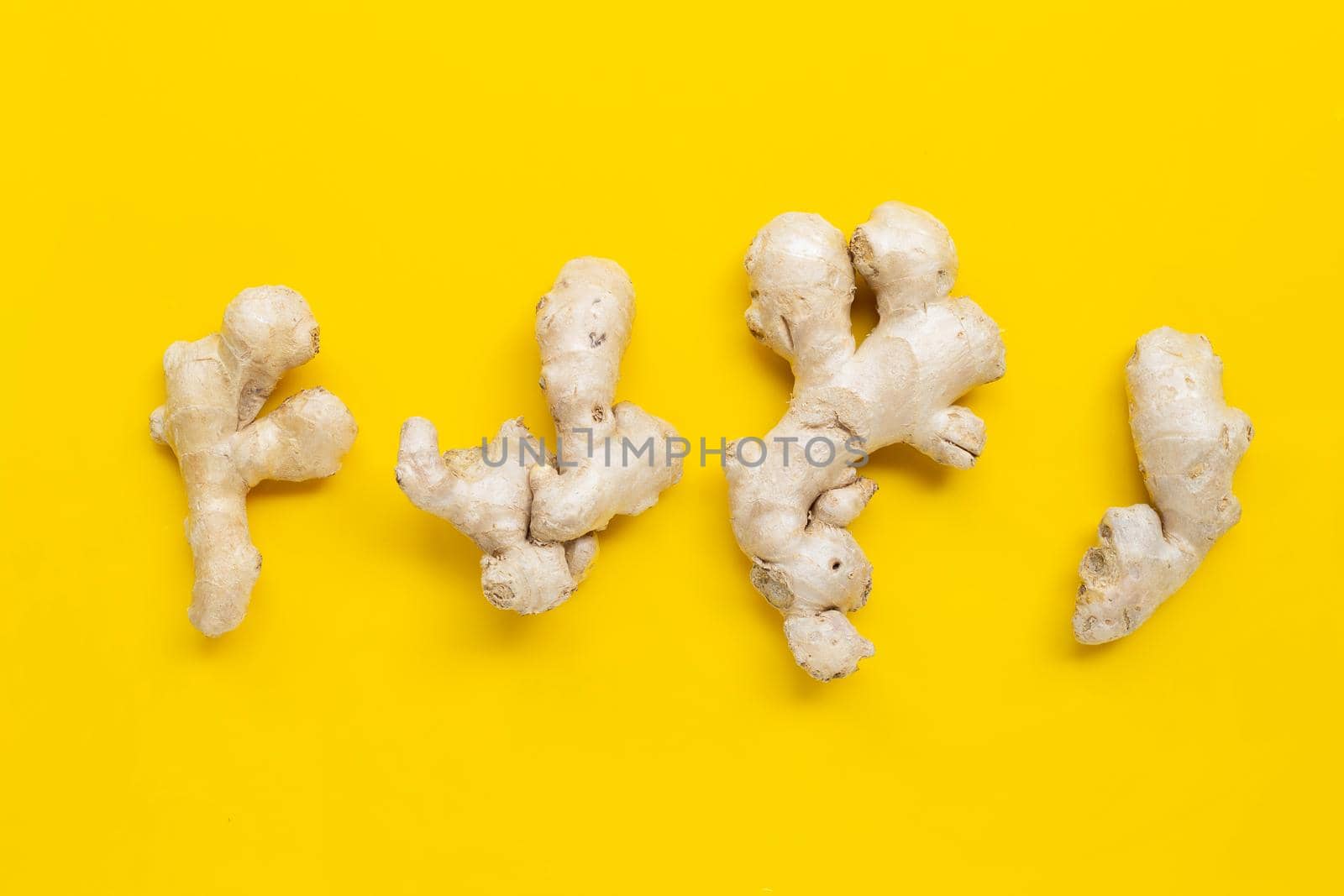 Ginger on yellow background. Top view