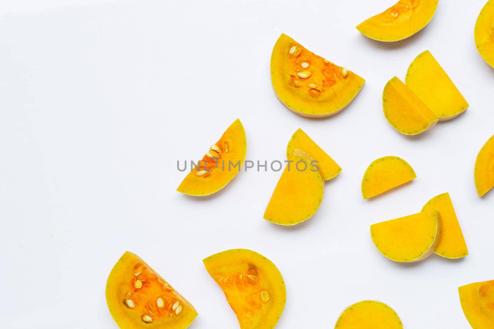 Cut and slices butternut squash on white background.