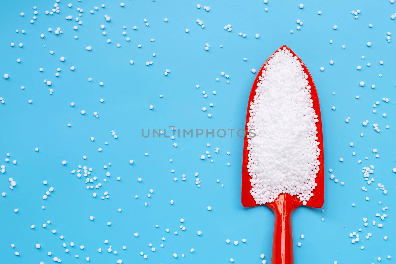 Chemical plant urea fertilizer on blue background. 