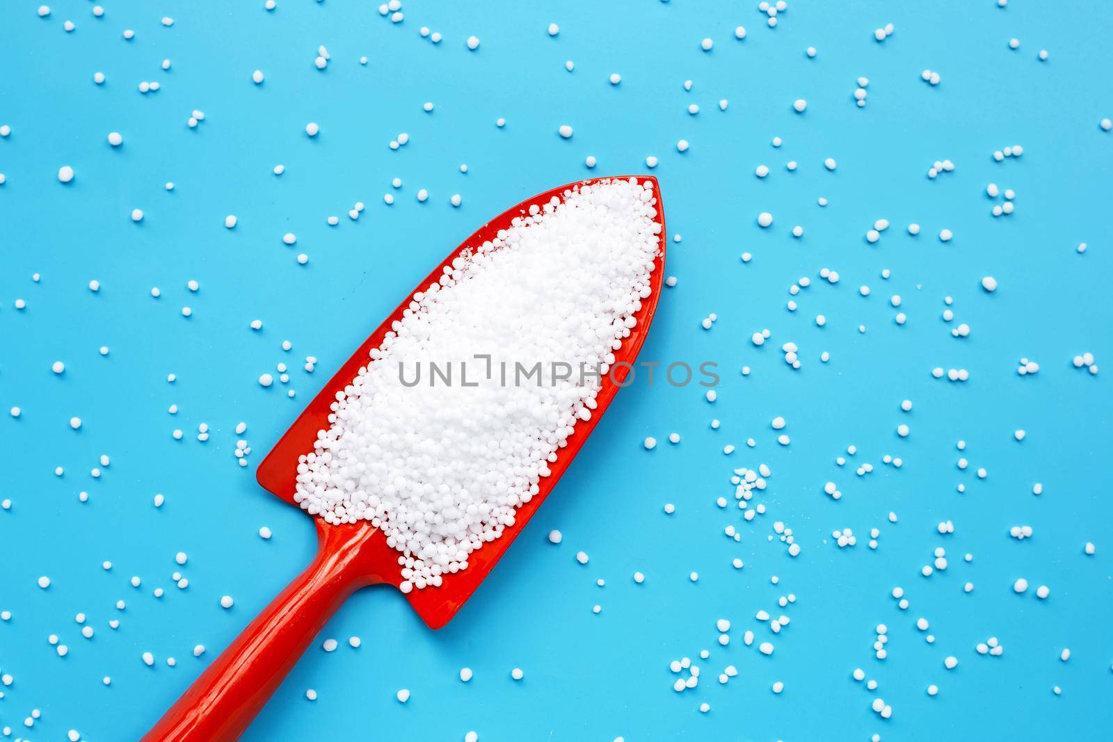 Chemical plant urea fertilizer on blue background. 