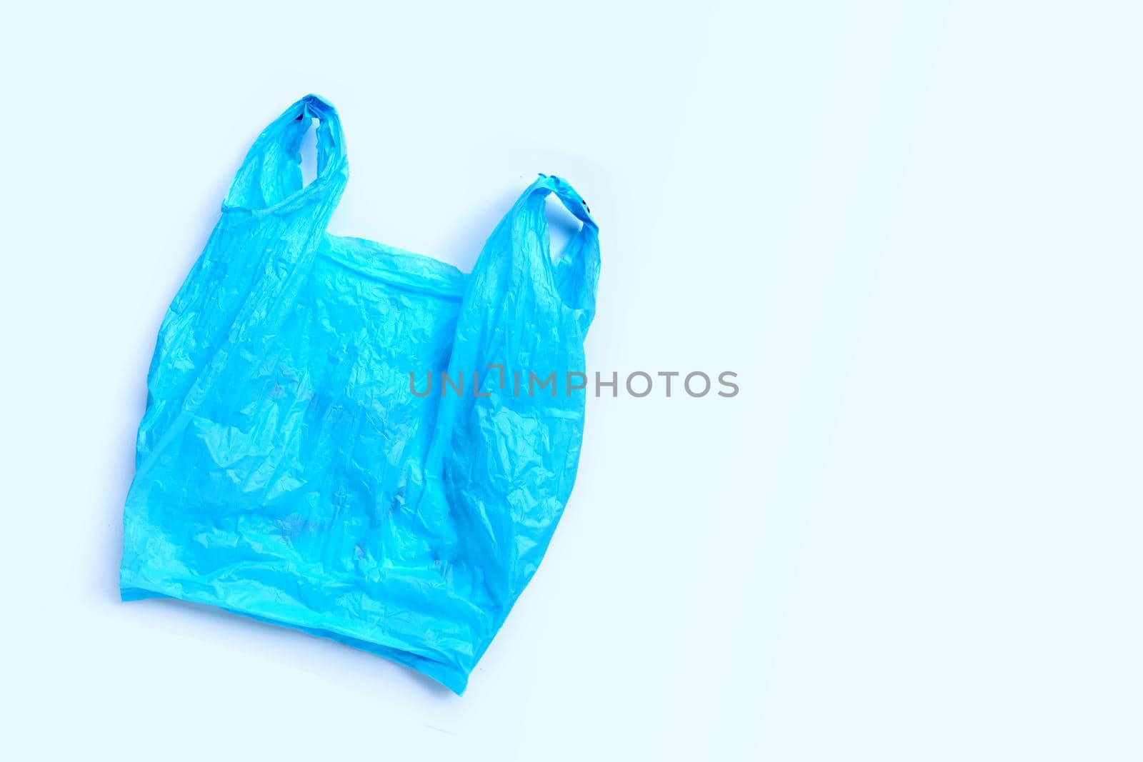 Colorful plastic bags on white background. Copy space