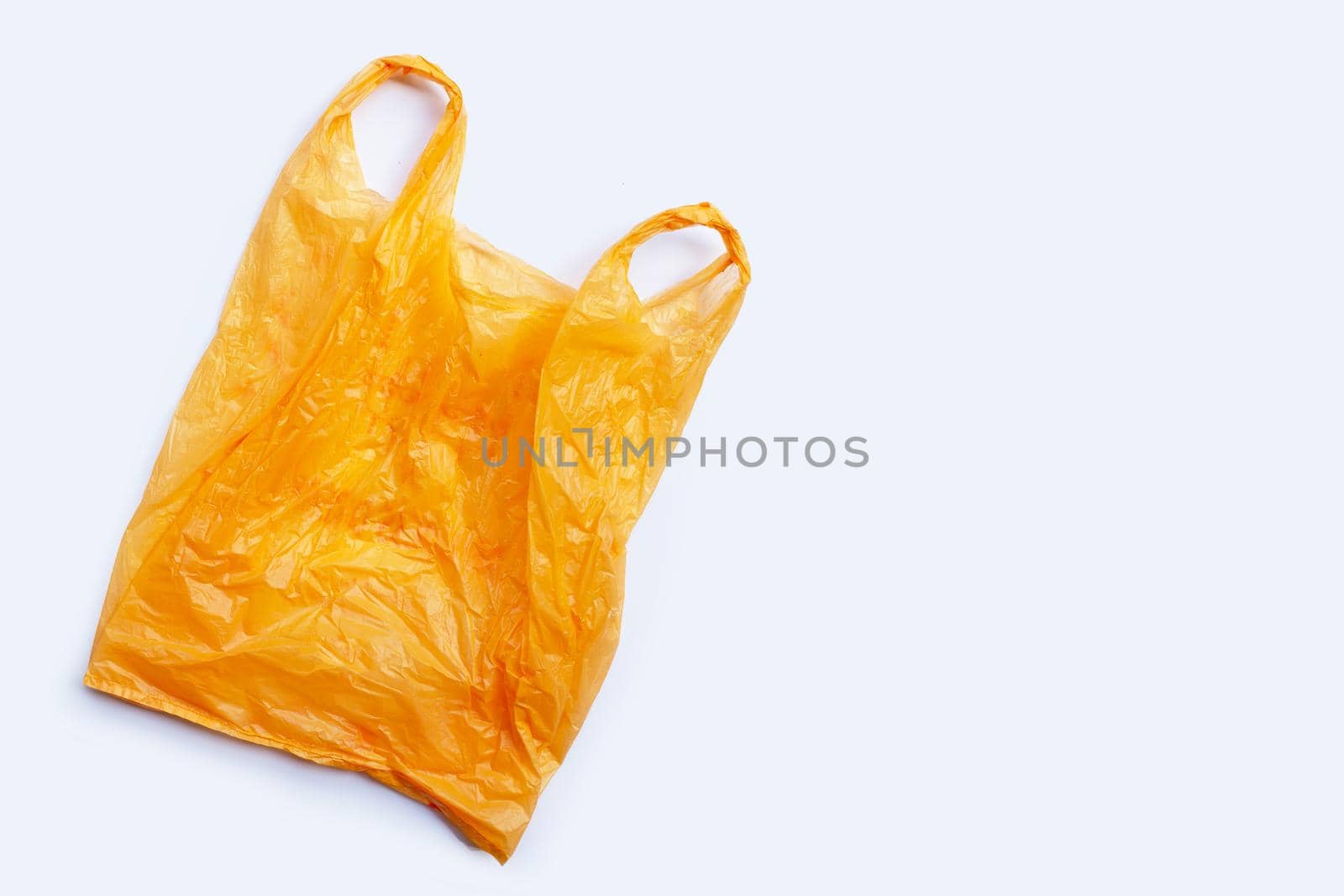 Colorful plastic bags on white background. Copy space