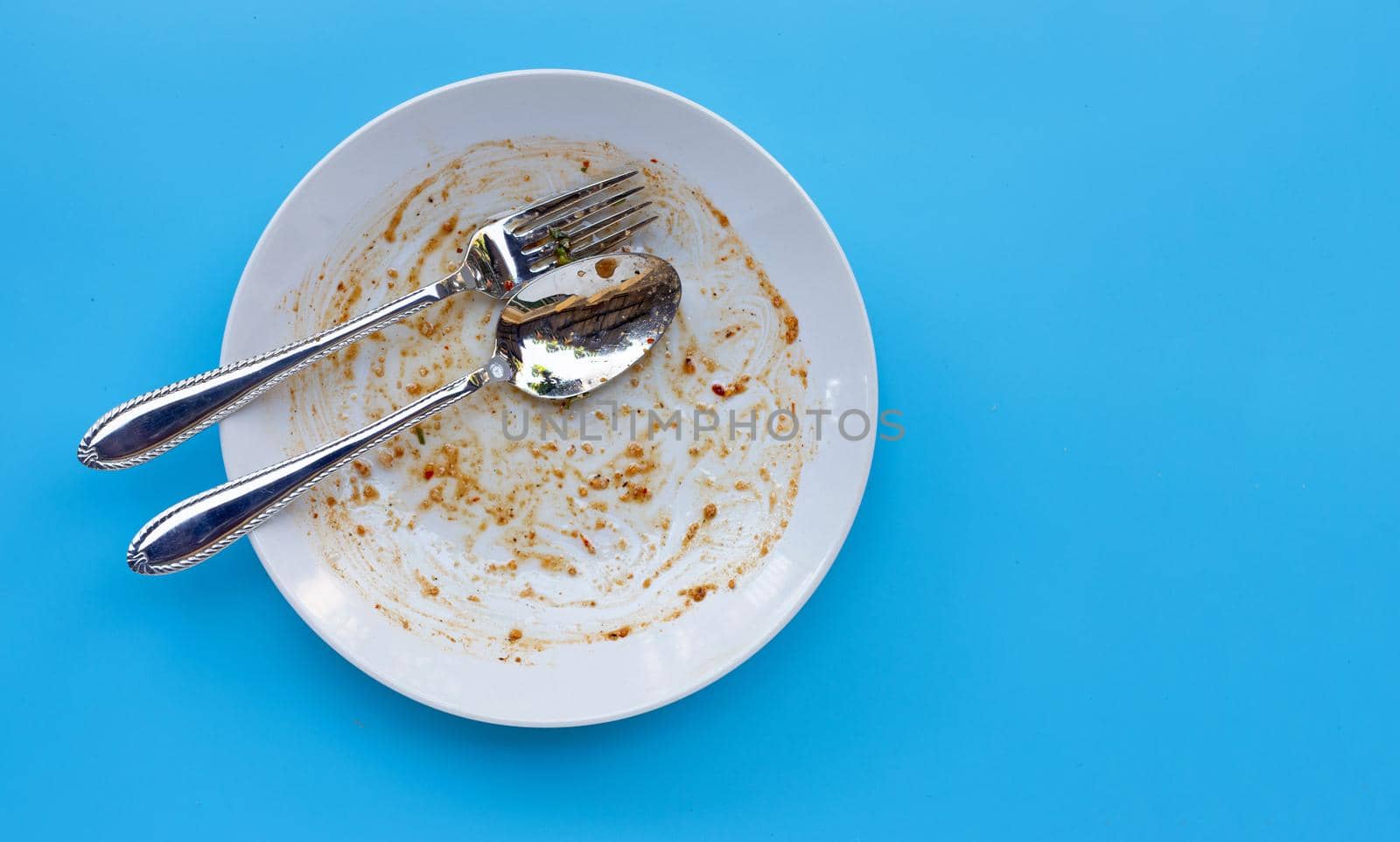 Dirty dish on blue background. Top view