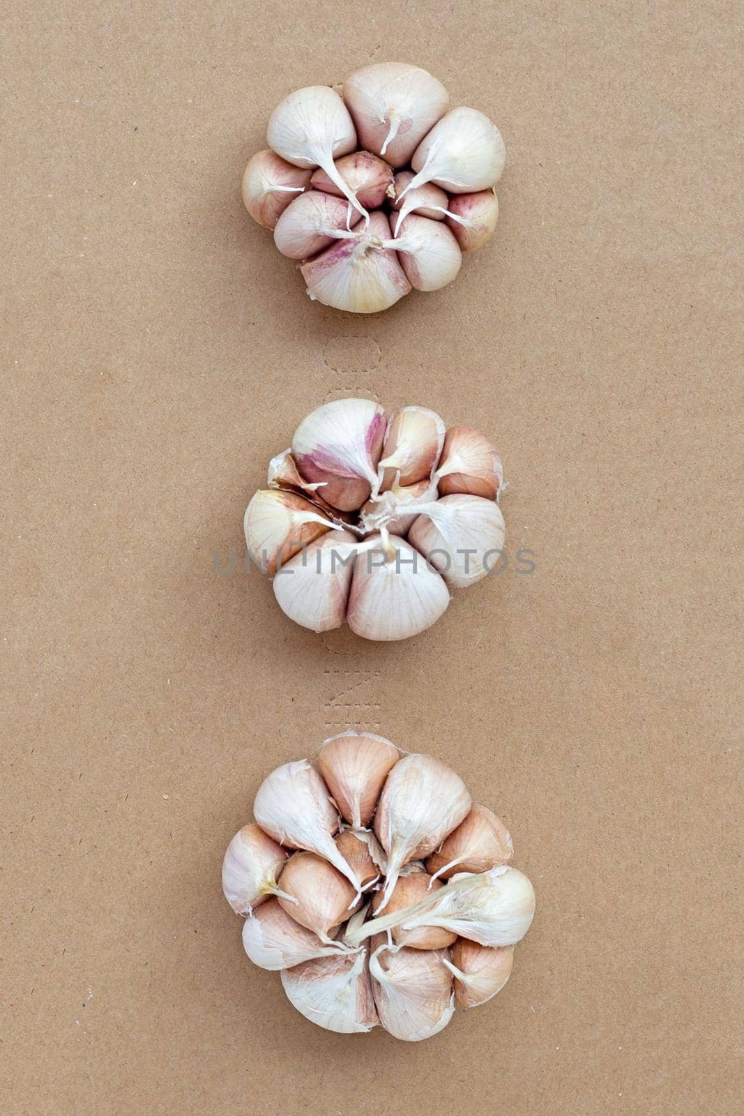 Cooking ingredients, Garlic on brown paper background.  by Bowonpat