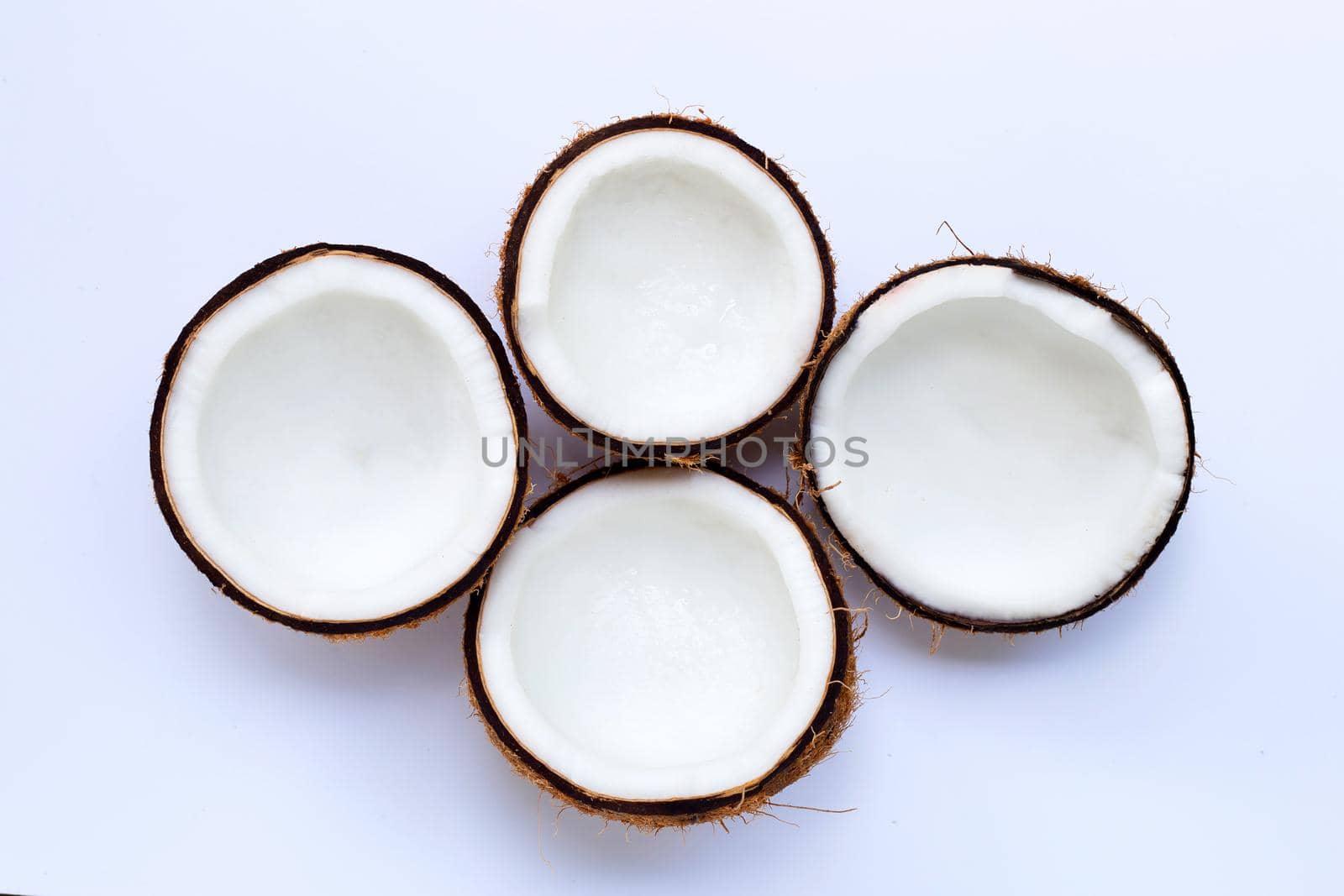 Half coconuts on white background. Top view