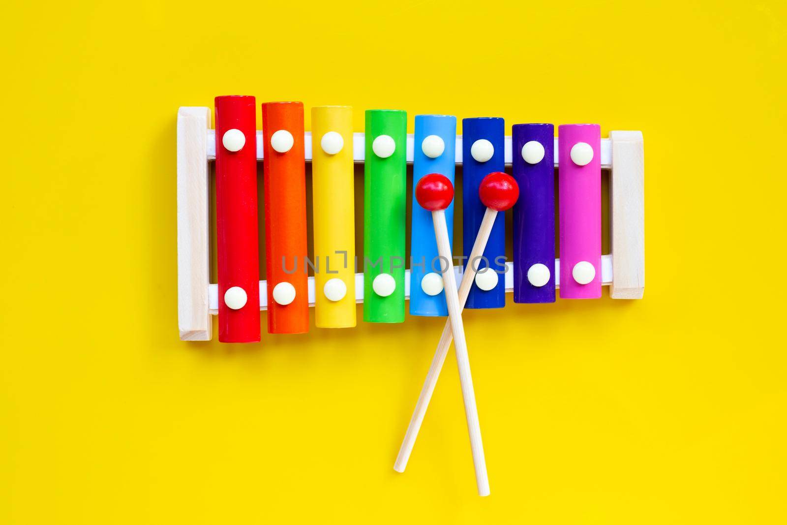 Colorful xylophone on yellow background.