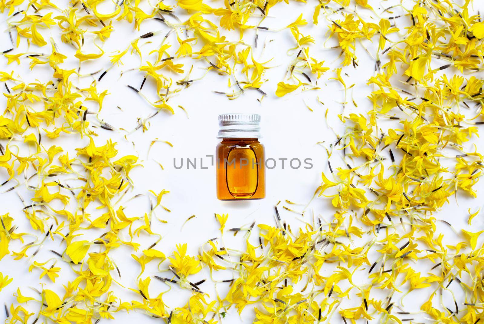 Essential oil of marigold flower on white
