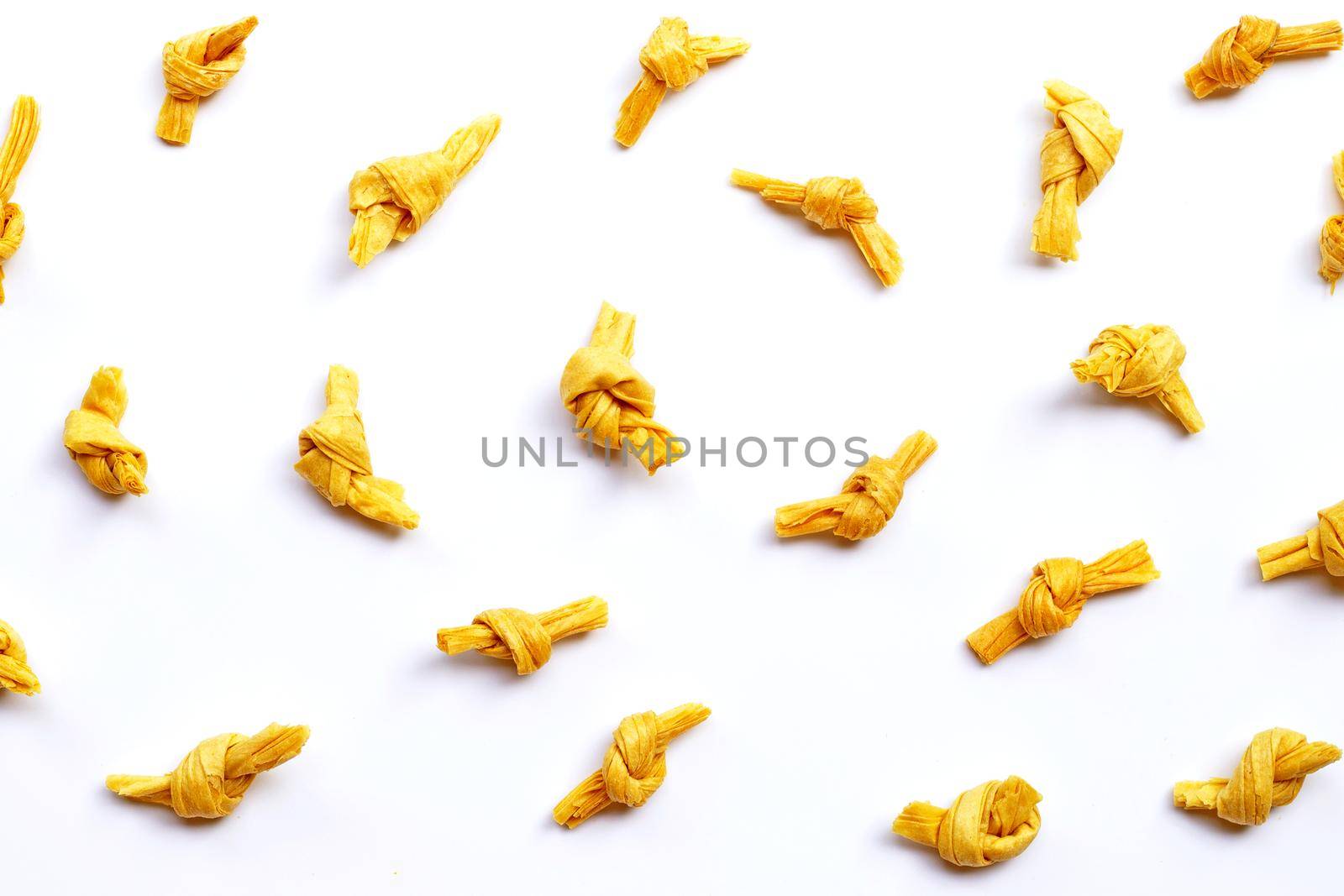 Dried bean curd knot on white background. Top view