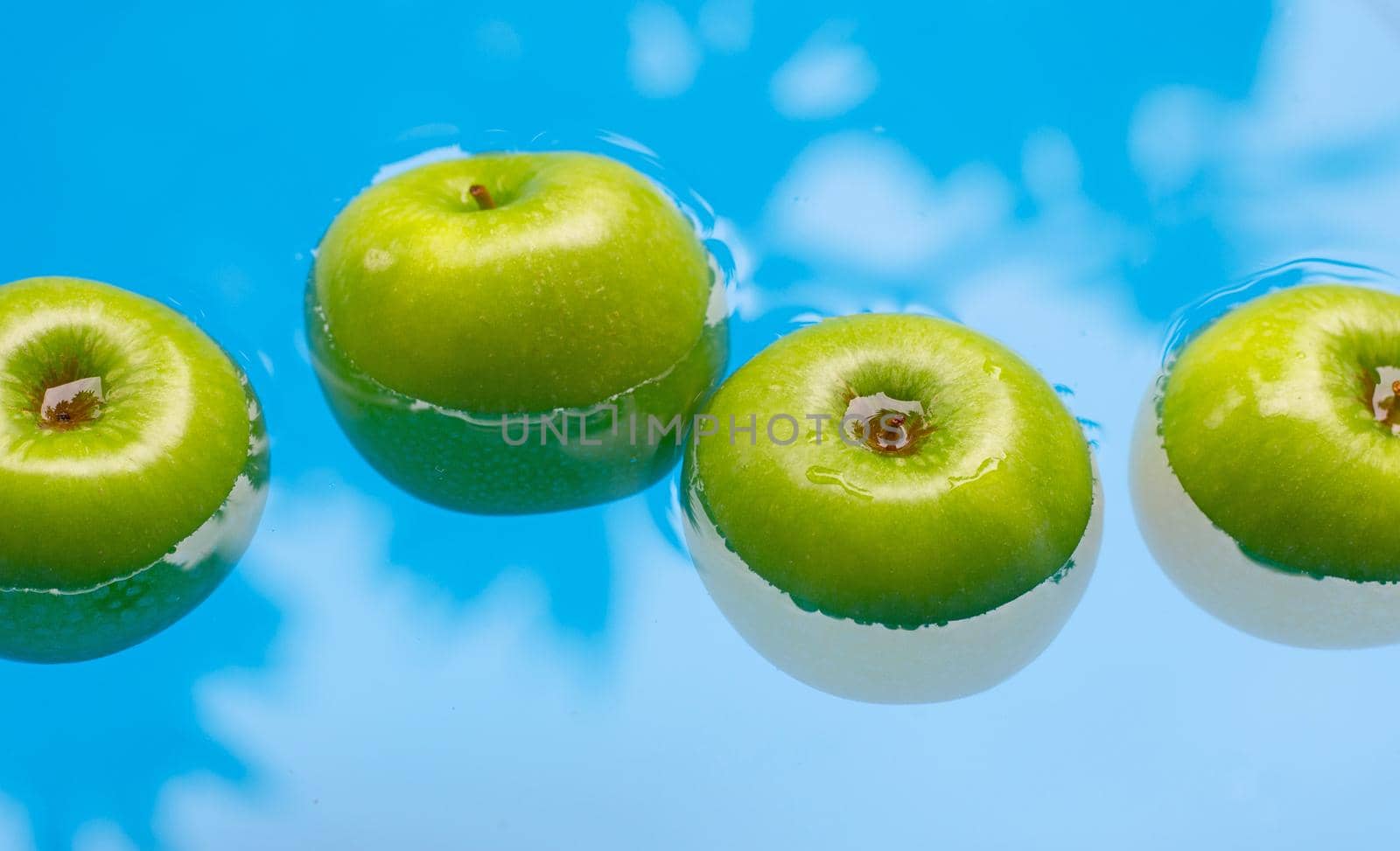 Washing fresh green apples in the water