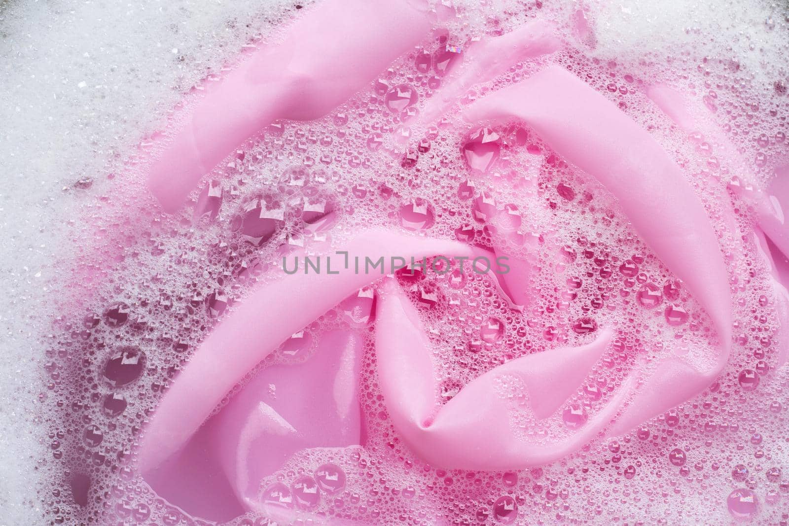 Color clothes soak in powder detergent water dissolution. Laundry concept