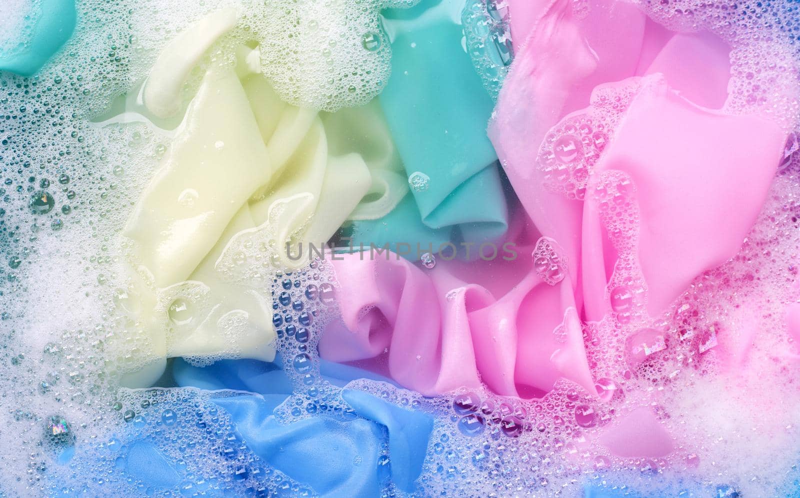 Color clothes soak in powder detergent water dissolution. Laundry concept