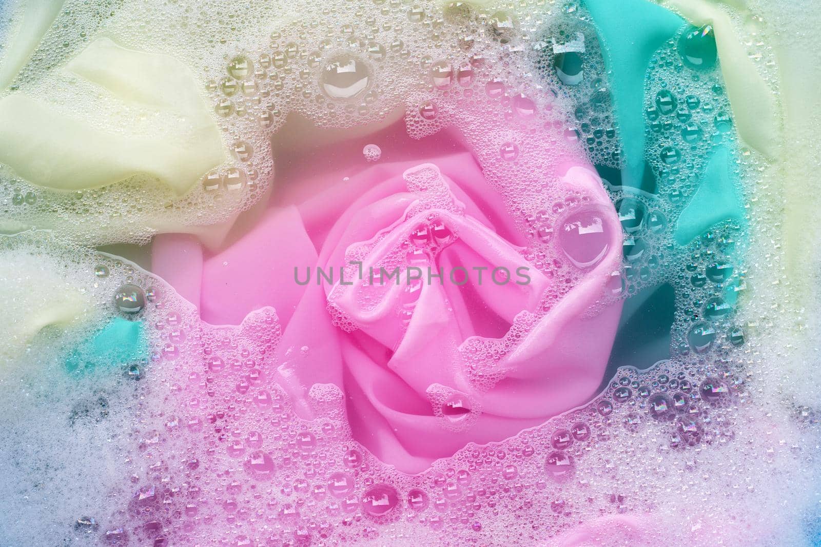 Color clothes soak in powder detergent water dissolution. Laundry concept