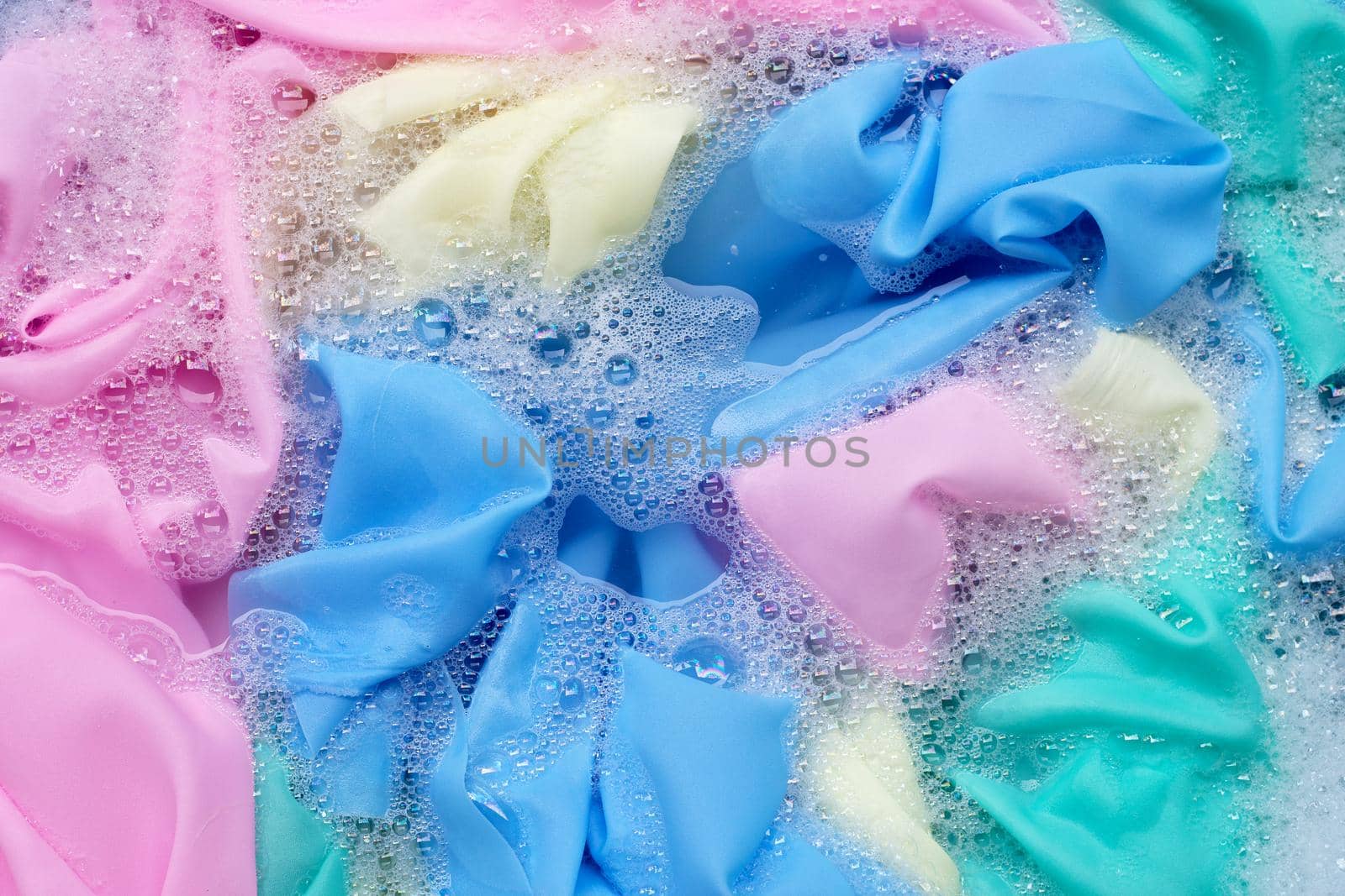 Color clothes soak in powder detergent water dissolution. Laundry concept