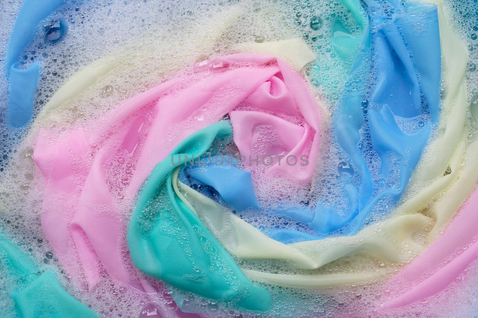 Color clothes soak in powder detergent water dissolution. Laundry concept